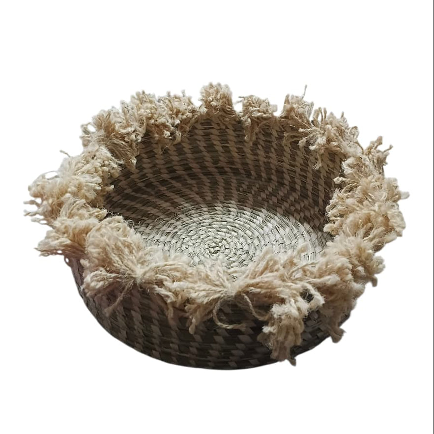 Woven basket with decorative jute trim on a white background