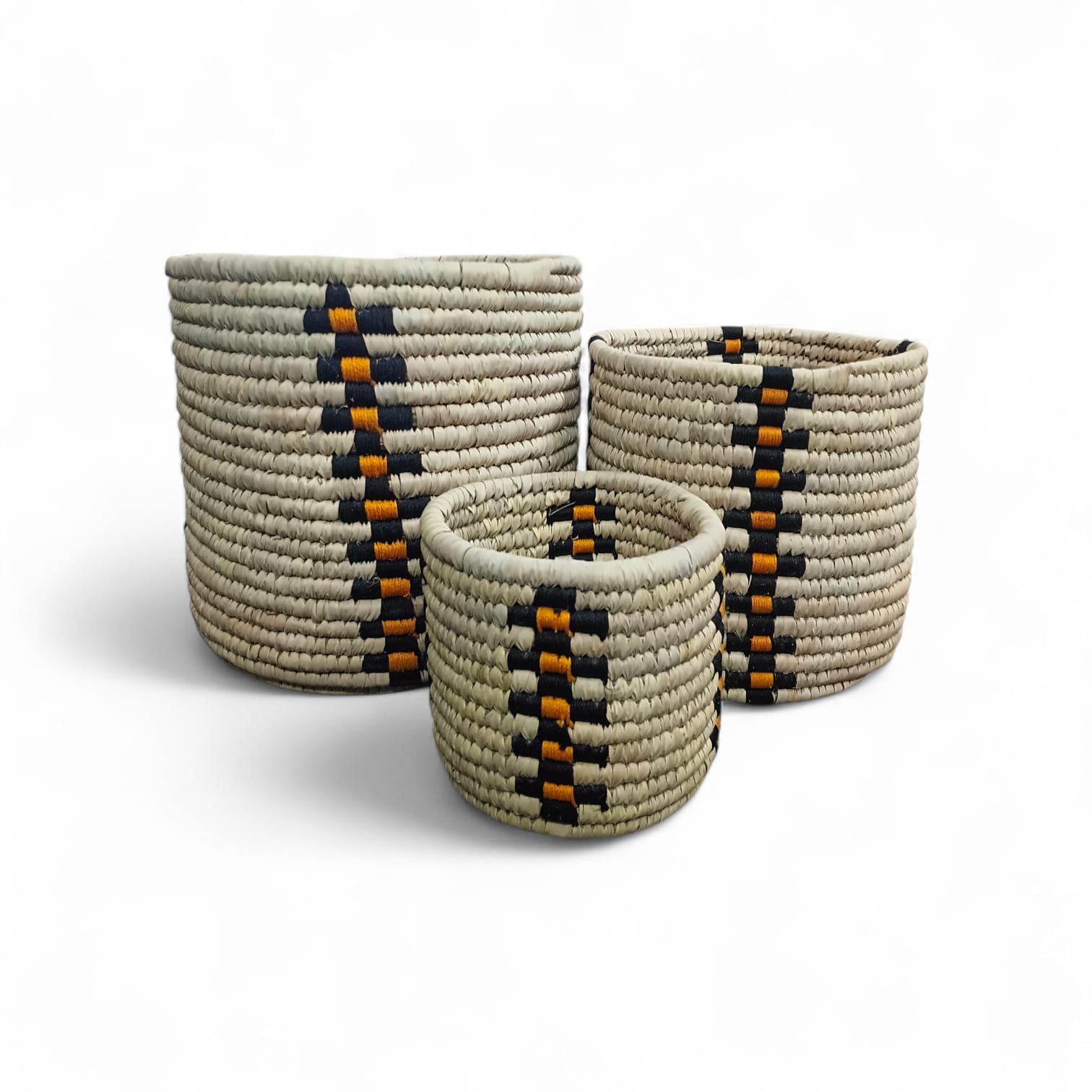 Three woven baskets with geometric patterns on a white background